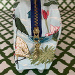 End view of Meadow Club toiletry bag in sky blue features a lily pond pattern
