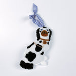 one black and white staffodshire dog felt christmas ornaments against a white background.