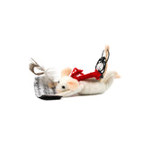 A felt mouse ornament posed as if flying with a red scarf, holding a feather pen and sheet music, and carrying a tiny black lantern on its back.