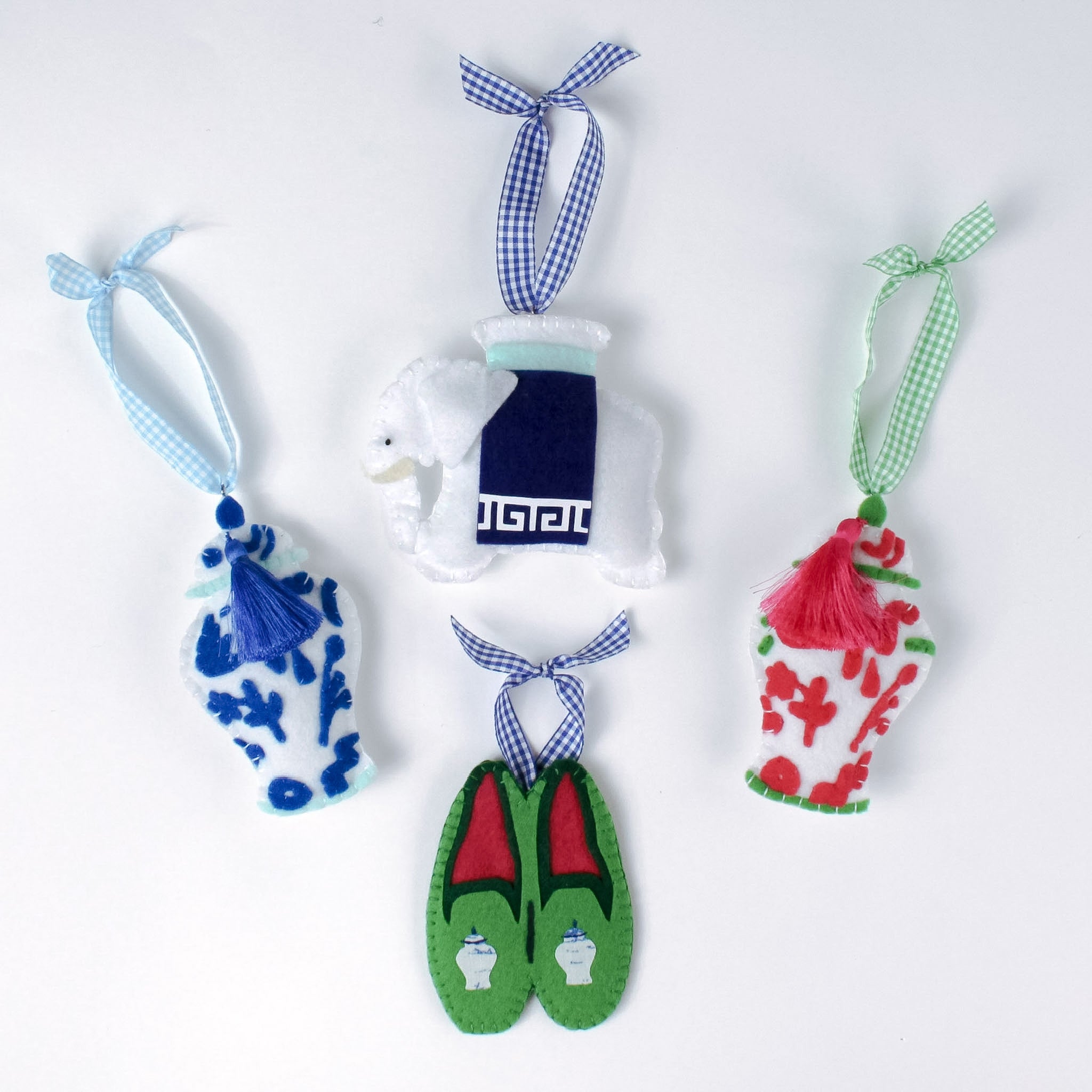 felt chinoiserie Christmas ornaments including a blue ginger jar, red ginger jar green loafers, and elephant on a white background.