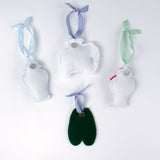 back of felt chinoiserie Christmas ornaments including a blue ginger jar, red ginger jar green loafers, and elephant on a white background.