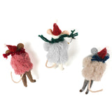 back of the Three festive felt mouse ornaments dressed in fuzzy holiday outfits and Santa hats, holding Christmas decorations like string lights, a wreath, and a gold bell.