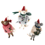 Three festive felt mouse ornaments dressed in fuzzy holiday outfits and Santa hats, holding Christmas decorations like string lights, a wreath, and a gold bell.