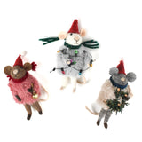 Three festive felt mouse ornaments dressed in fuzzy holiday outfits and Santa hats, holding Christmas decorations like string lights, a wreath, and a gold bell.