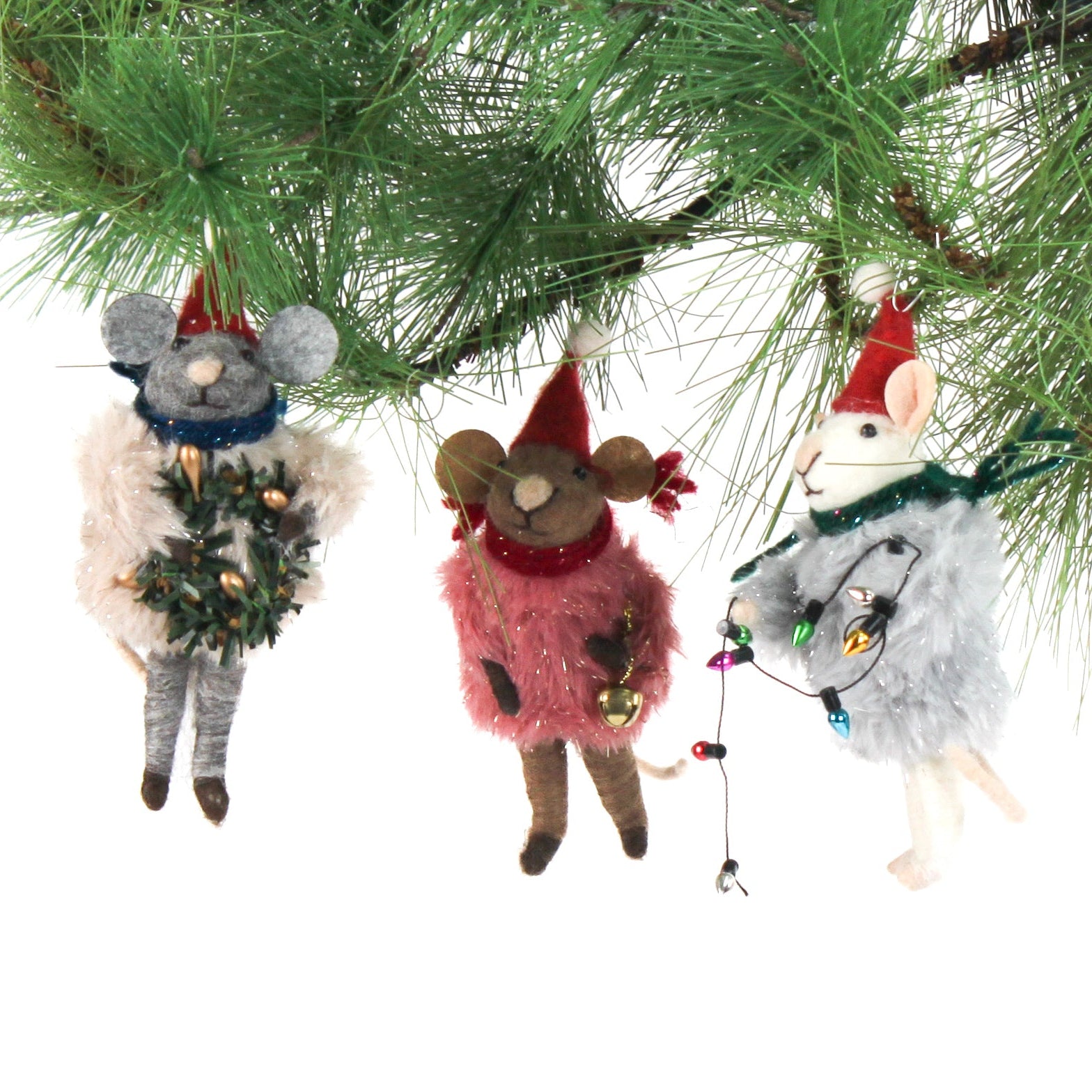 Three festive felt mouse ornaments dressed in fuzzy holiday outfits and Santa hats, holding Christmas decorations like string lights, a wreath, and a gold bell.