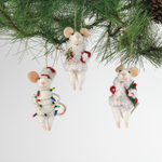 Three white felt mouse ornaments dressed in cozy winter outfits, one wrapped in colorful holiday lights, one holding a Christmas wreath, and one holding a festive ornament