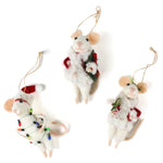 Three white felt mouse ornaments dressed in cozy winter outfits, one wrapped in colorful holiday lights, one holding a Christmas wreath, and one holding a festive ornament