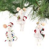 Three white felt mouse ornaments dressed in cozy winter outfits, one wrapped in colorful holiday lights, one holding a Christmas wreath, and one holding a festive ornament
