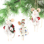 Three white felt mouse ornaments where 2 dressed in cozy winter outfits, one wrapped in colorful holiday lights, one holding a Christmas wreath, and one holding a festive ornament