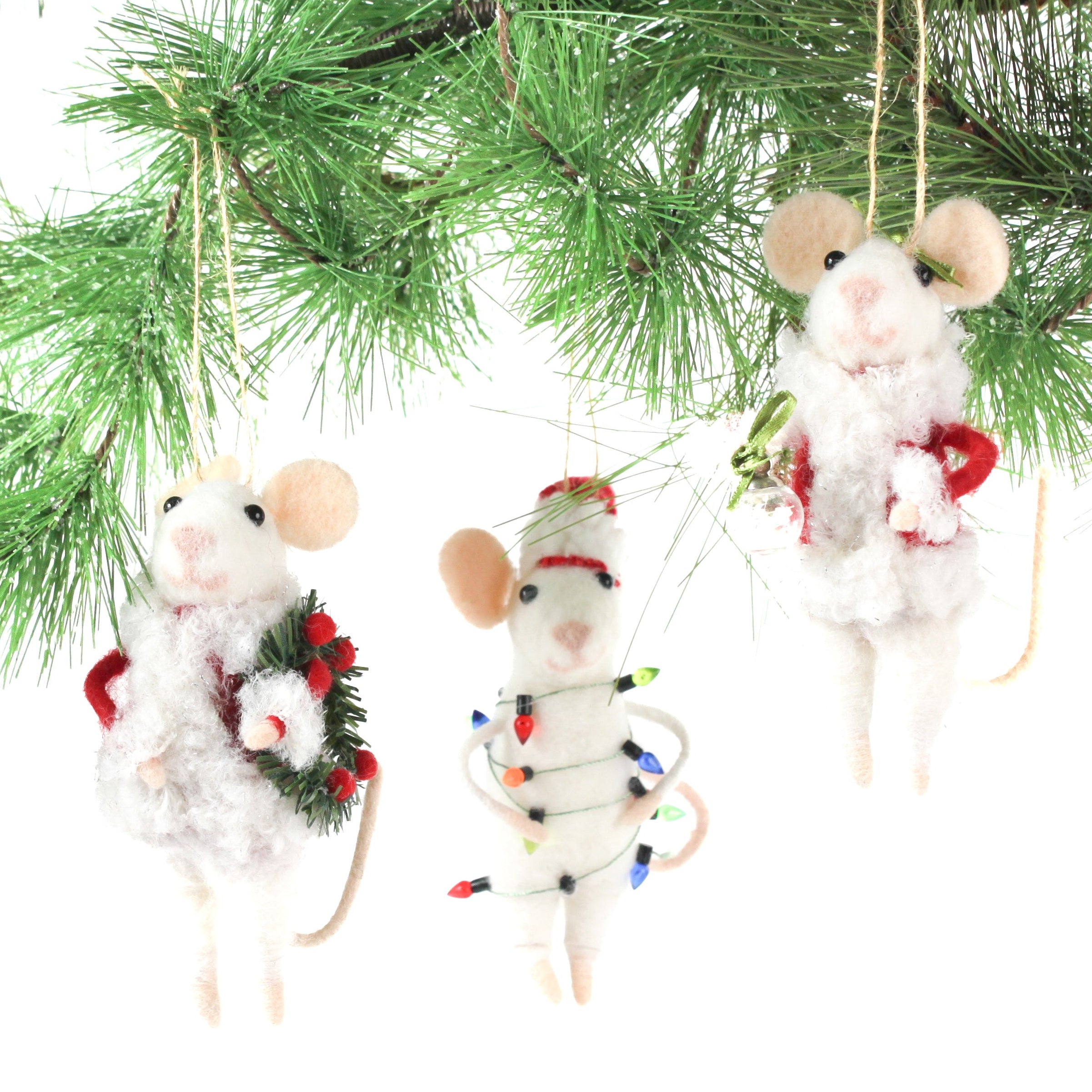 Three white felt mouse ornaments where 2 dressed in cozy winter outfits, one wrapped in colorful holiday lights, one holding a Christmas wreath, and one holding a festive ornament