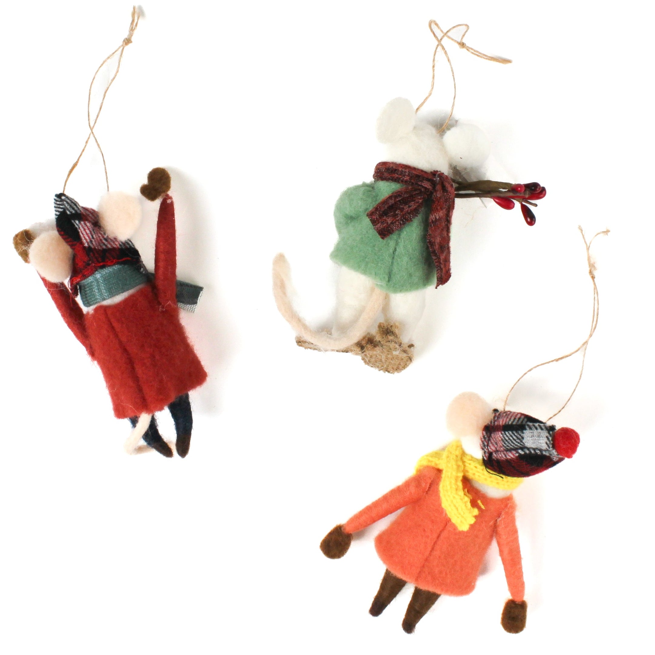 back of Three felt mouse ornaments dressed for winter—one in a red coat and plaid hat tossing a snowball, one in an orange coat with a yellow scarf holding a snowball, and one in a green sweater holding red berries—lying in white surface.
