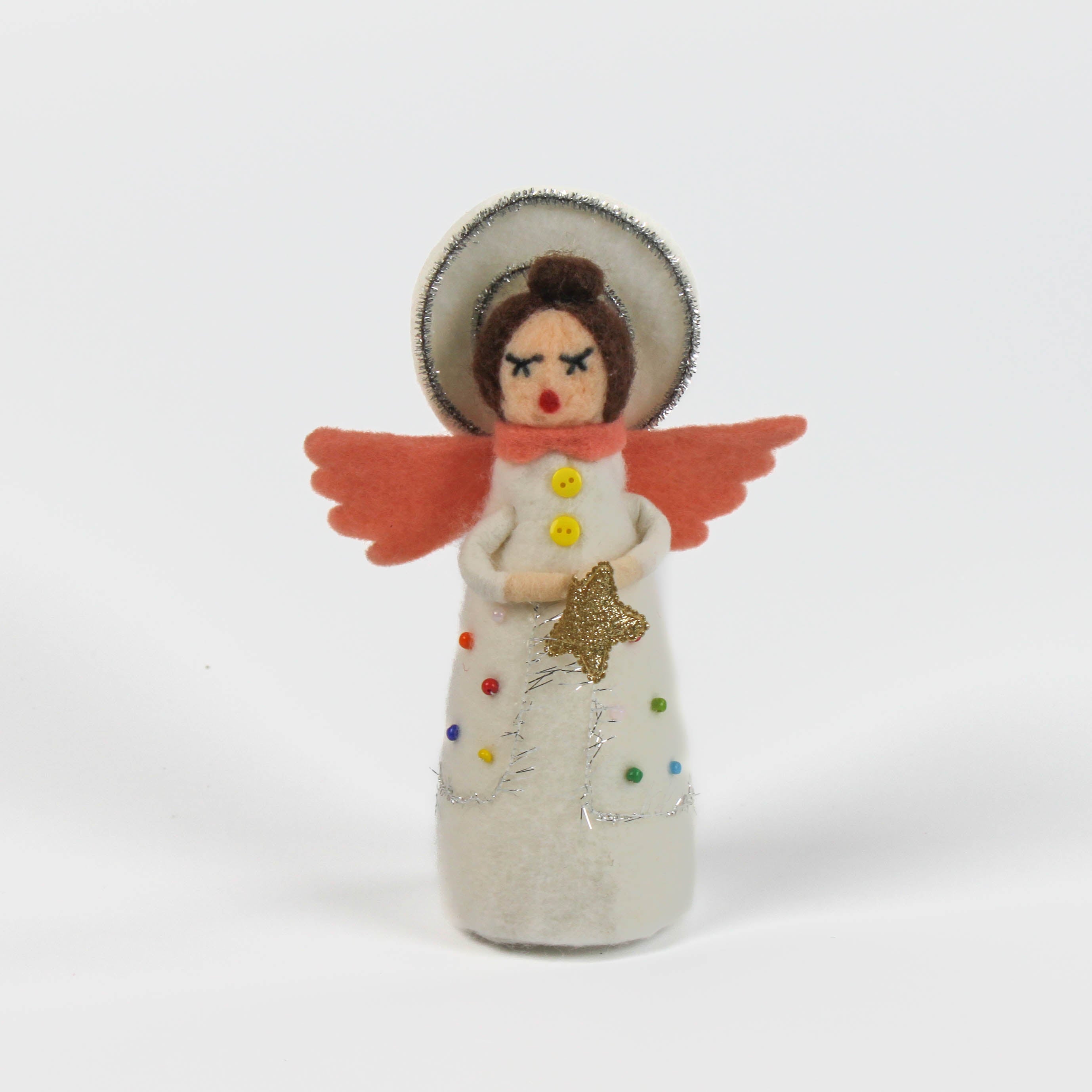 angel christmas table decoration made from felt with colorful clothing and pink wings on a white background
