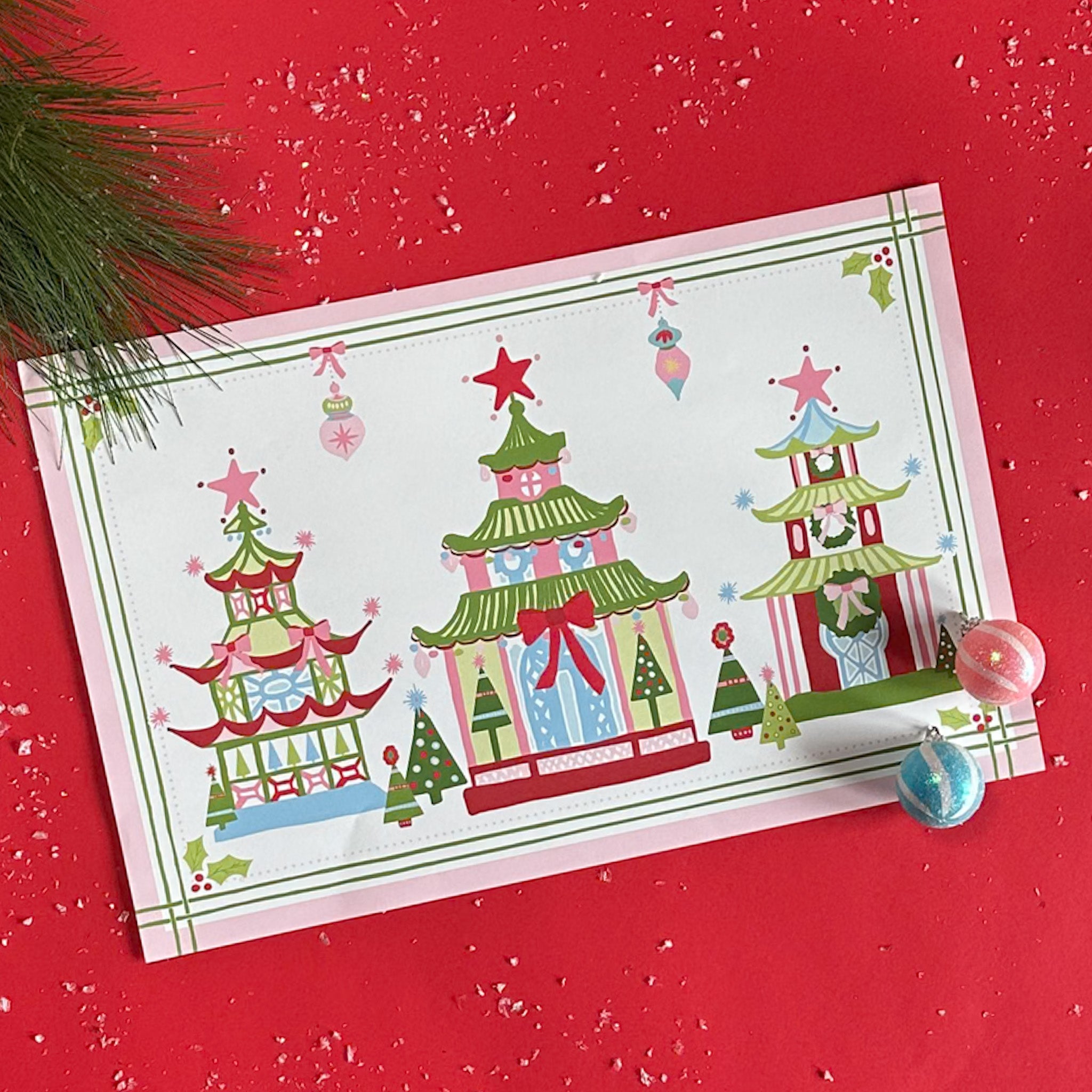 Festive Pagodas Rectangular Paper Christmas Placemats on a red surface