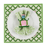 Festive pagoda square paper placemats in a white background. A white plate is placed on top of it with a cloth and a pagoda napkin ring