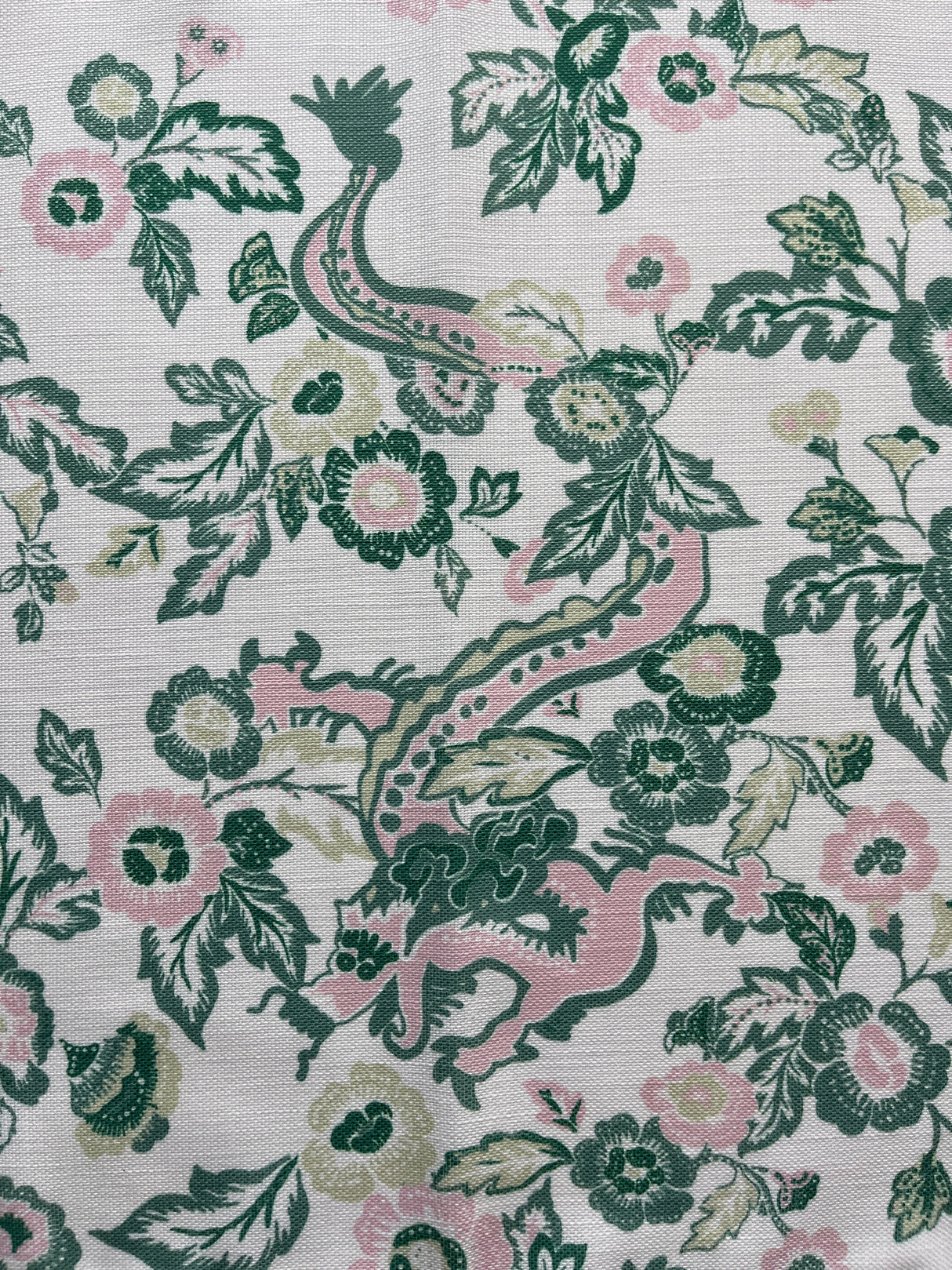 Flat view of Madcap Cottage's East of the Sun chinoiserie print cloth dinner napkin showing detail of dragon and florals in pattern.