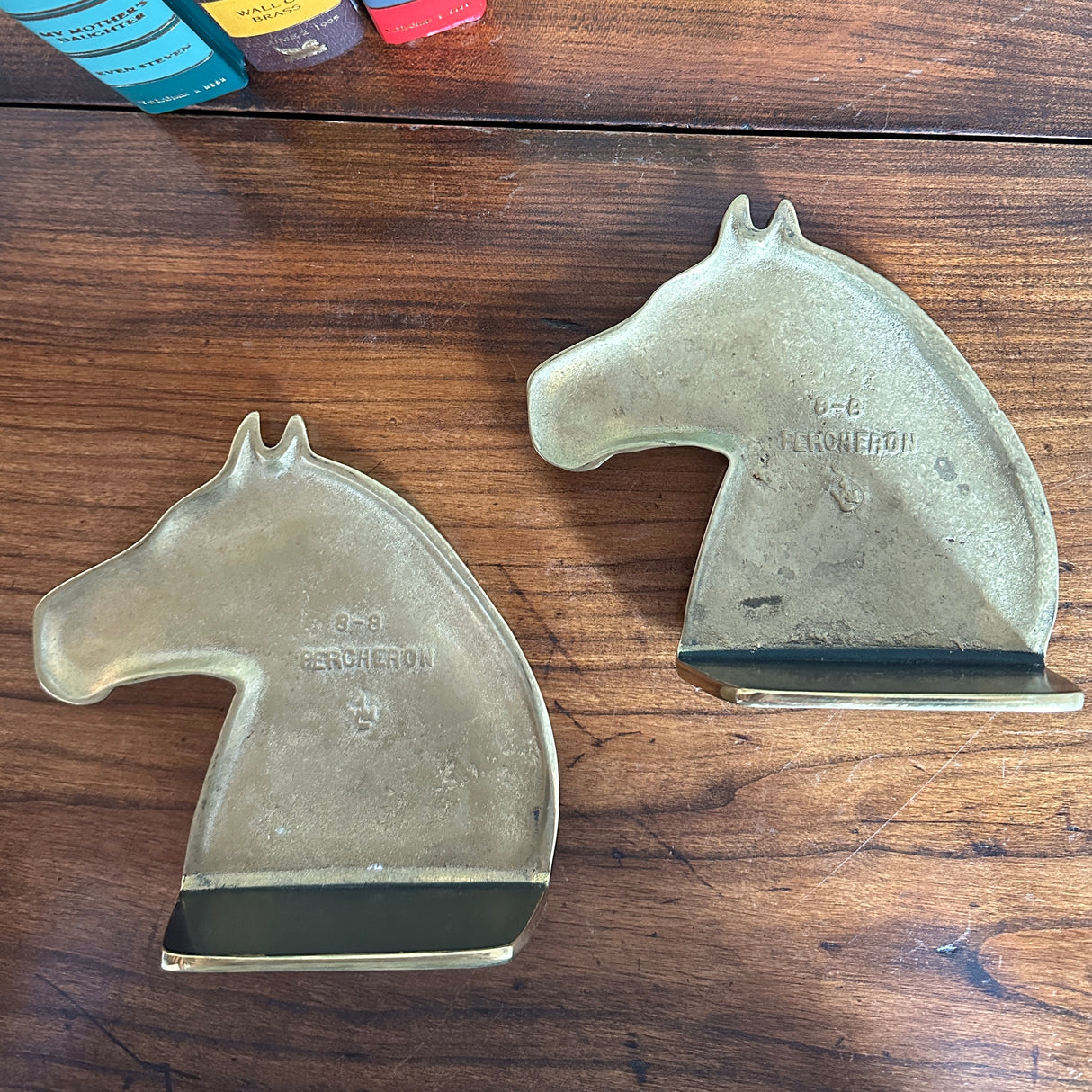 The reverse sides of two brass horse bookends