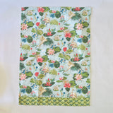 Floral tea towel featuring water lily and herom motifs