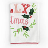 A folded Christmas tea towel with holly motifs and text that reads Holly Jolly Christmas