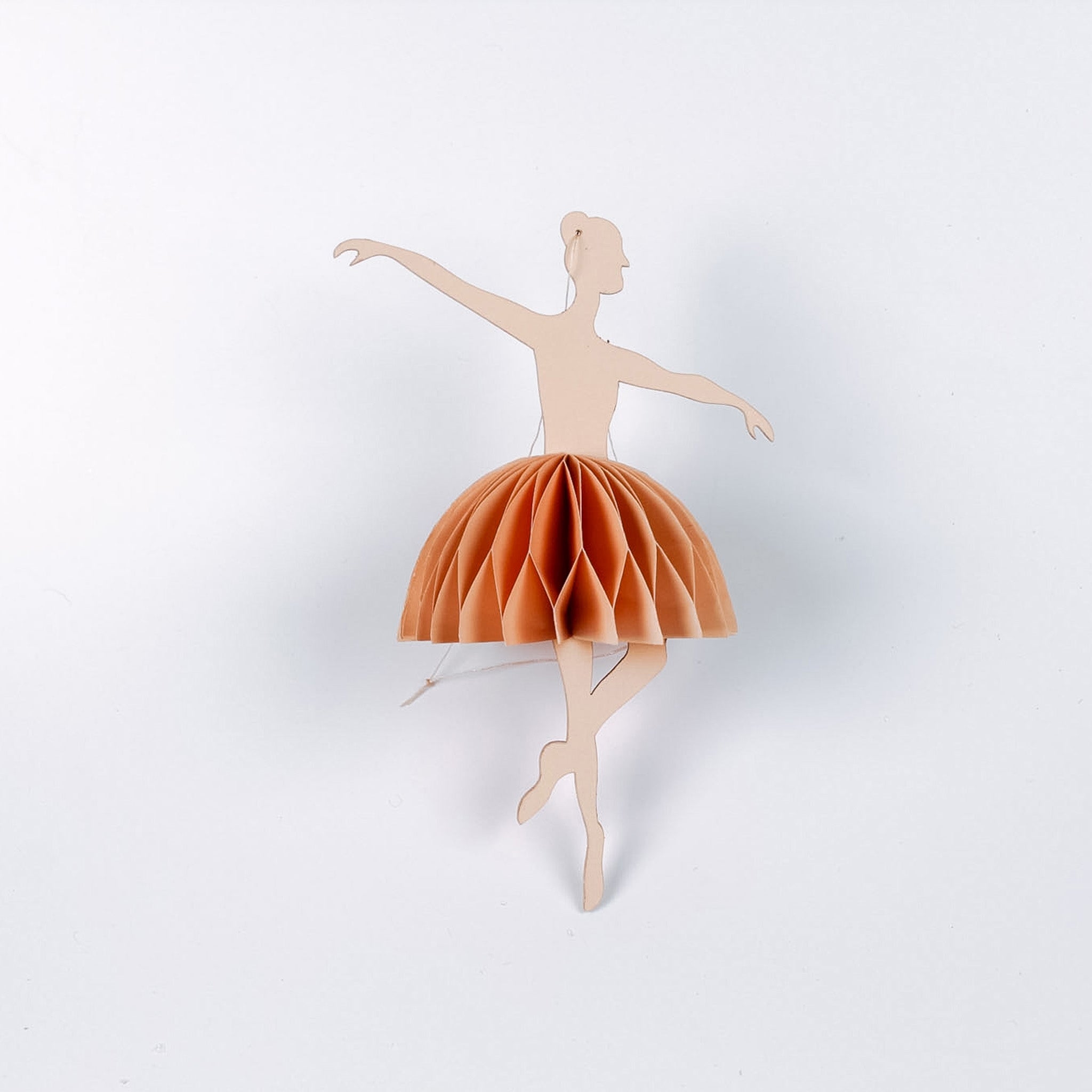 paper ballerina christmas ornament on a white background