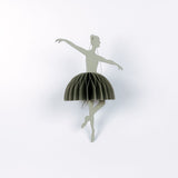 Decorative ballerina christmas ornament with a green skirt on a white background