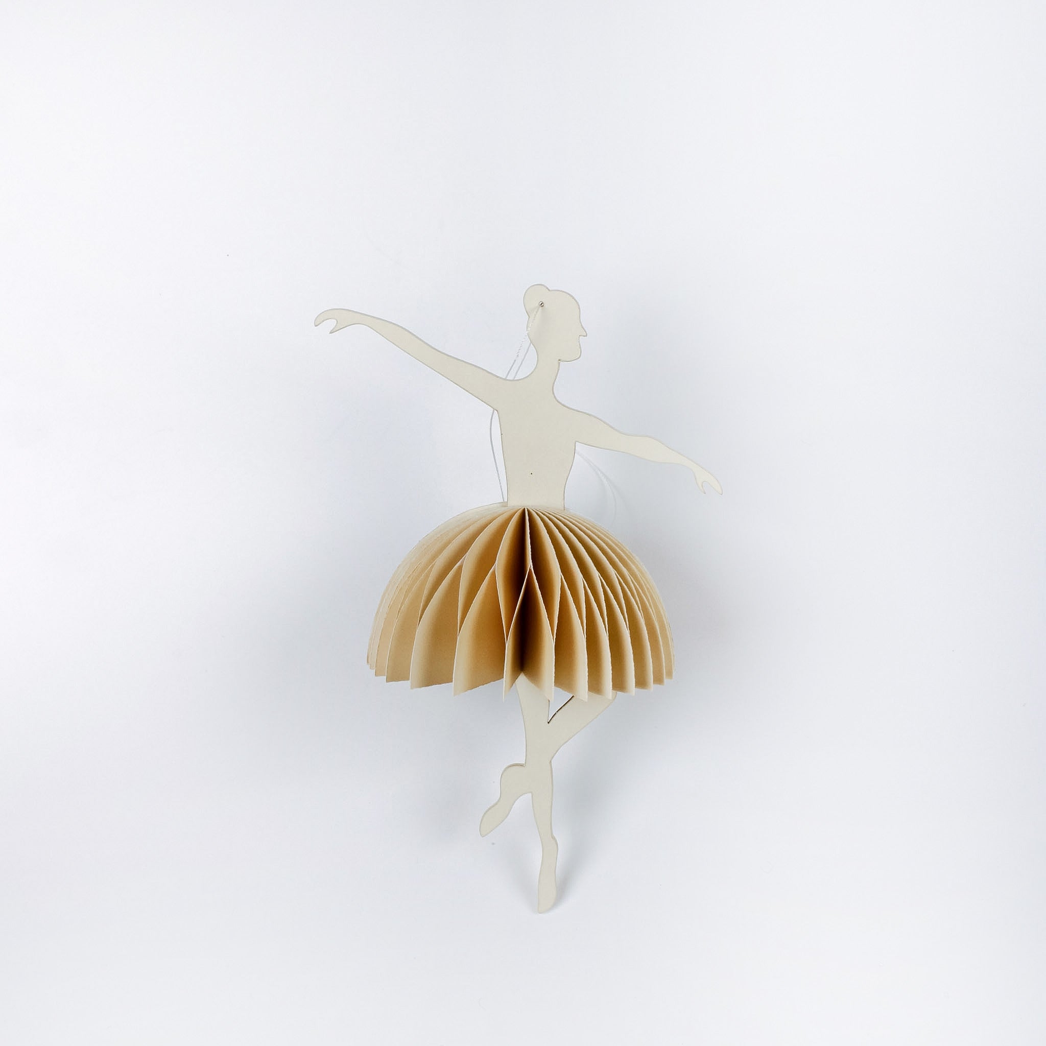 Decorative ballerina christmas ornament with beige skirt on a white background