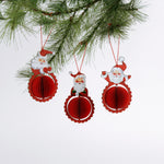 Set of three folding paper Santa Christmas ornaments in vibrant red with honeycomb-style bases