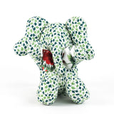 Green and white patterned stuffed elephant toy with a red bow.