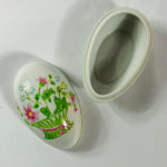 Open frog-themed Tastesetter decorative box showing hand-painted lid and smooth ceramic interior