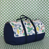 Front 3/4 view of Strawberry Hill duffle bag on a green and white backdrop
