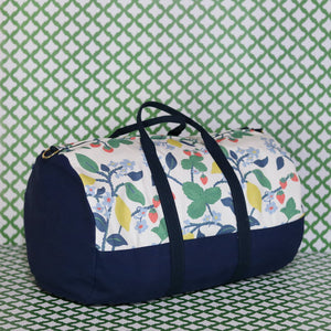 Front 3/4 view of Strawberry Hill duffle bag on a green and white backdrop