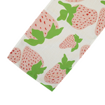 Garden Party Strawberry cloth table runner designed by madcap cottage with motifs of large pink and green strawberries with green stems.