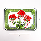Rectangular placemat featuring red geranium flowers with green patterned border, dimensions of 18" x 14" on a white background.