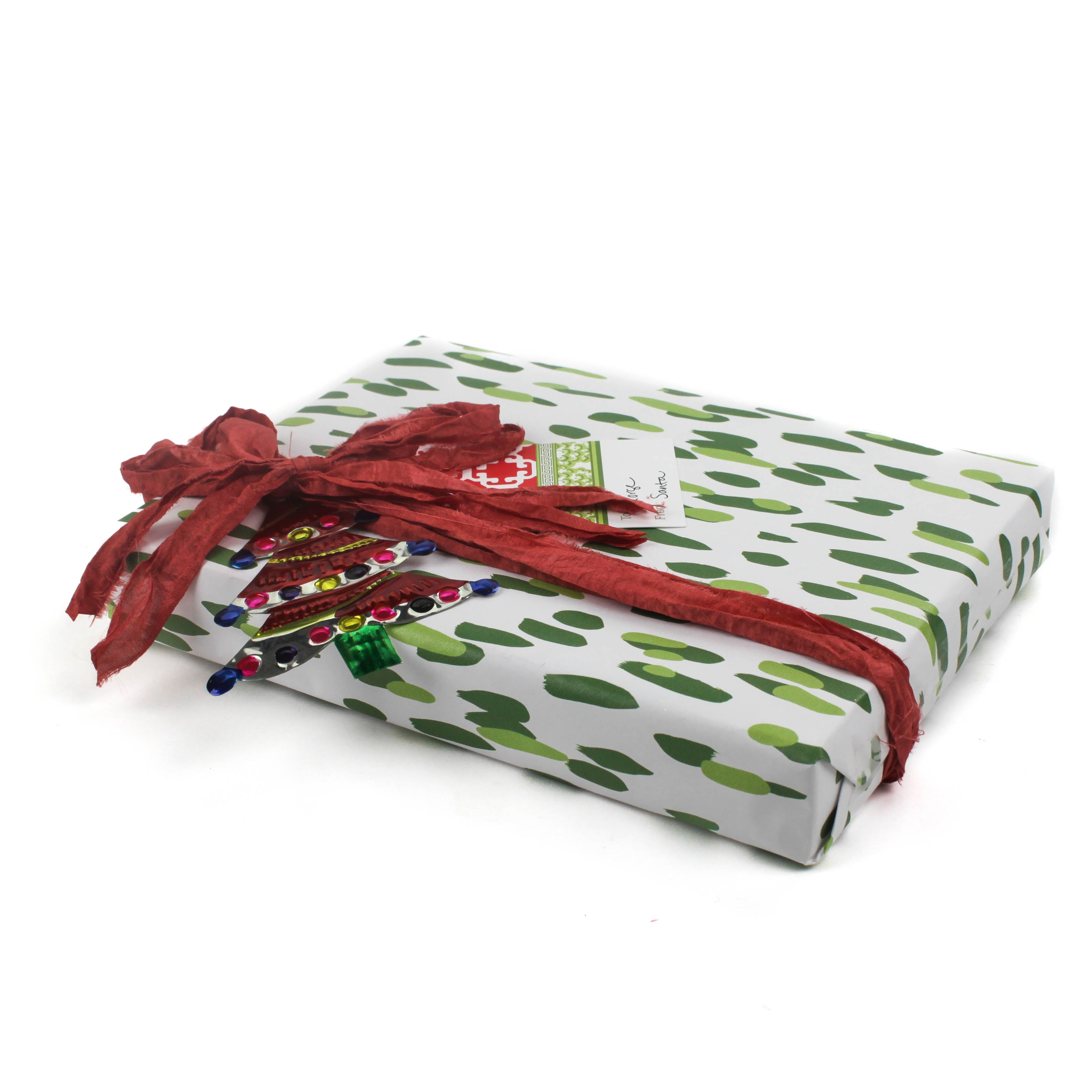A wrapping paper in painterly patterns and green in color.