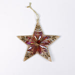 Gilt metal star shaped Christmas ornament with red and crystal accents and a red gem at the center, displayed against a white background.