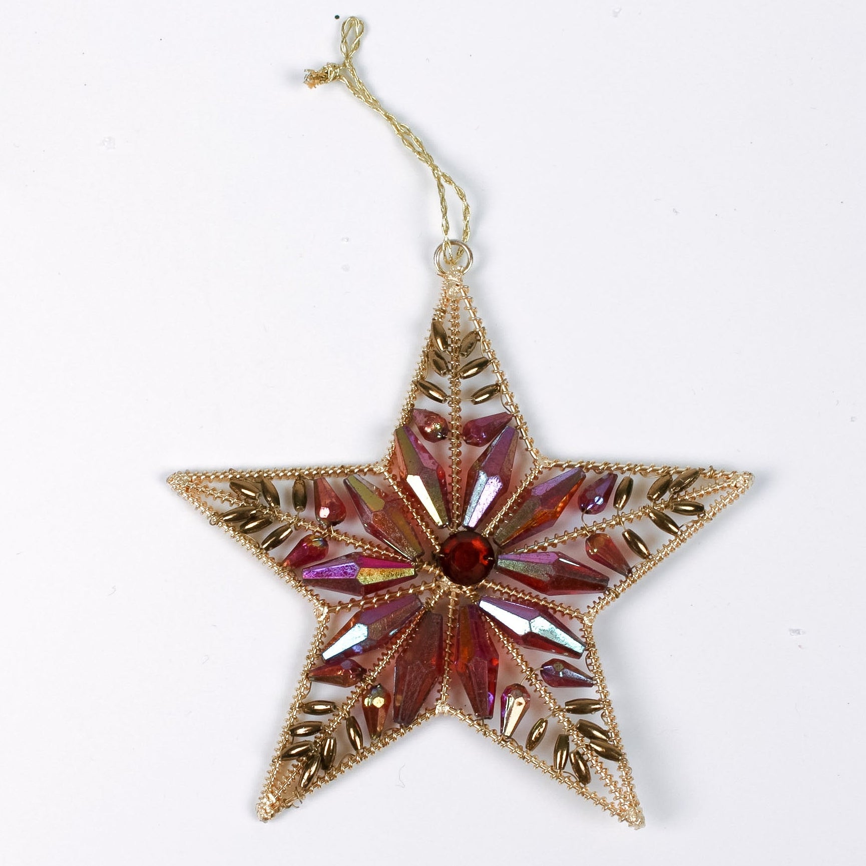 Gilt metal star shaped Christmas ornament with red and crystal accents and a red gem at the center, displayed against a white background.