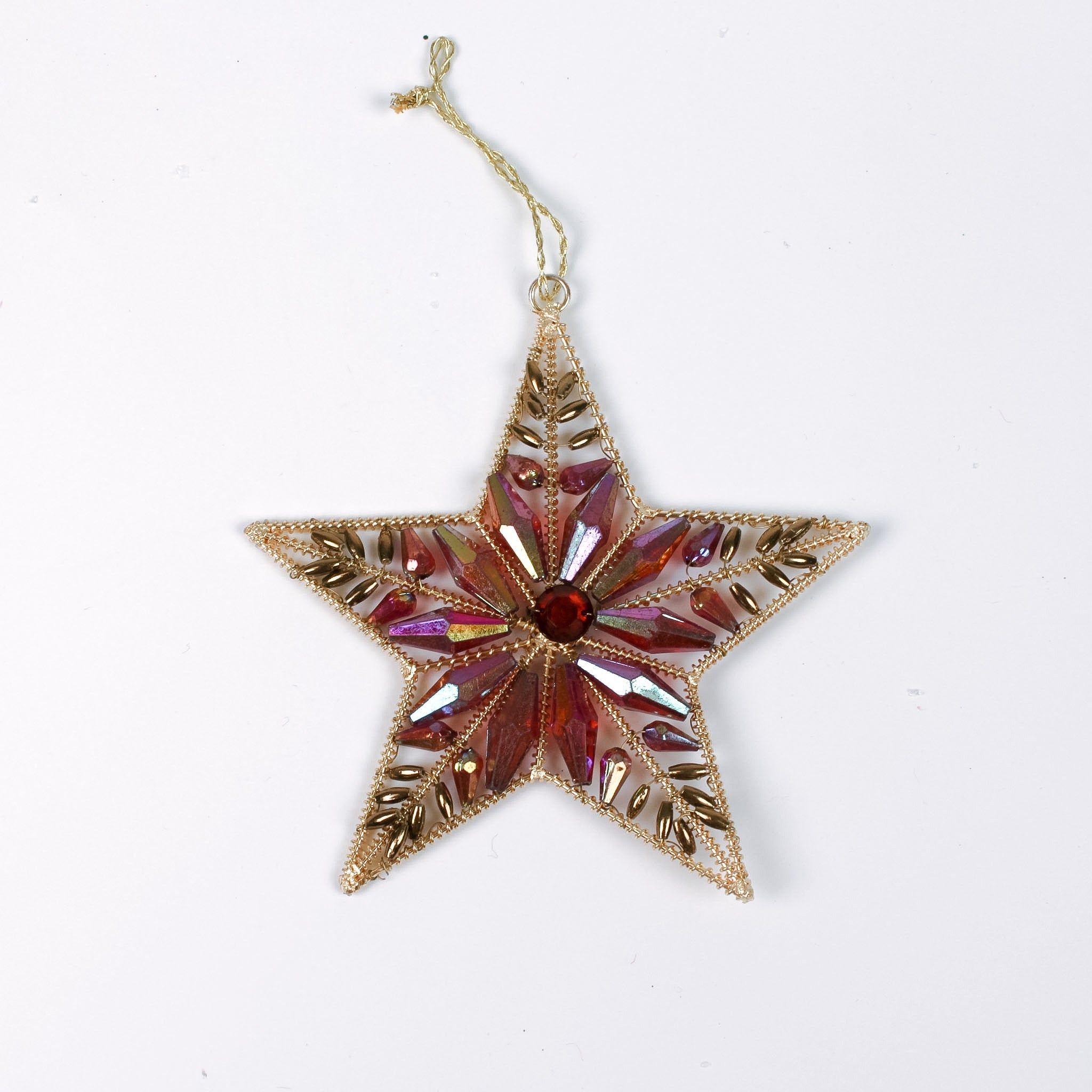 Gilt metal star shaped Christmas ornament with red and crystal accents and a red gem at the center, displayed against a white background.
