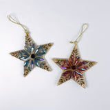 Two gilt metal star shaped Christmas ornaments decorated with colorful crystal accents