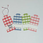 A set of three gingham patterned gift tags in red, blue, and green with a white space for personalization on the back, displayed on a white background.