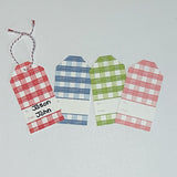 A set of three gingham patterned gift tags in red, blue, and green with a white space for personalization on the back, displayed on a white background.