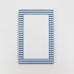 a luxury notepad with a blue gingham border
