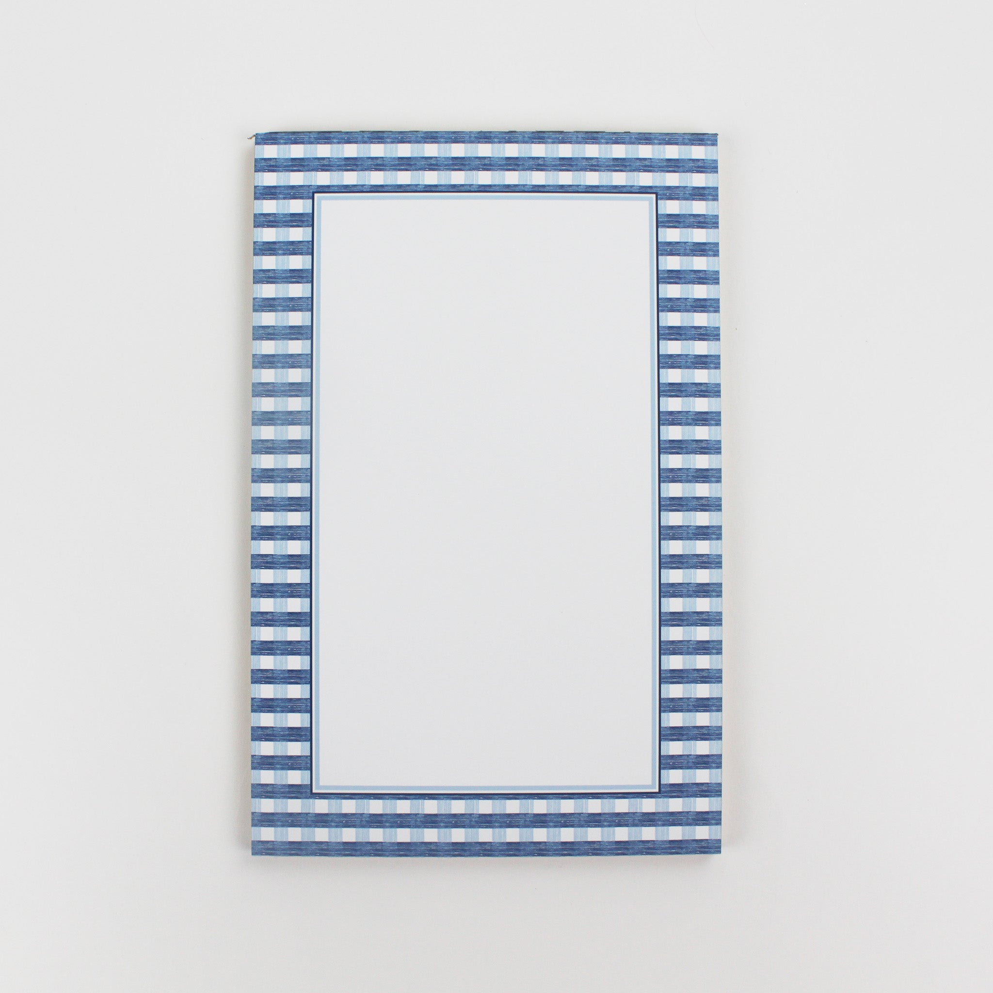a luxury notepad with a blue gingham border