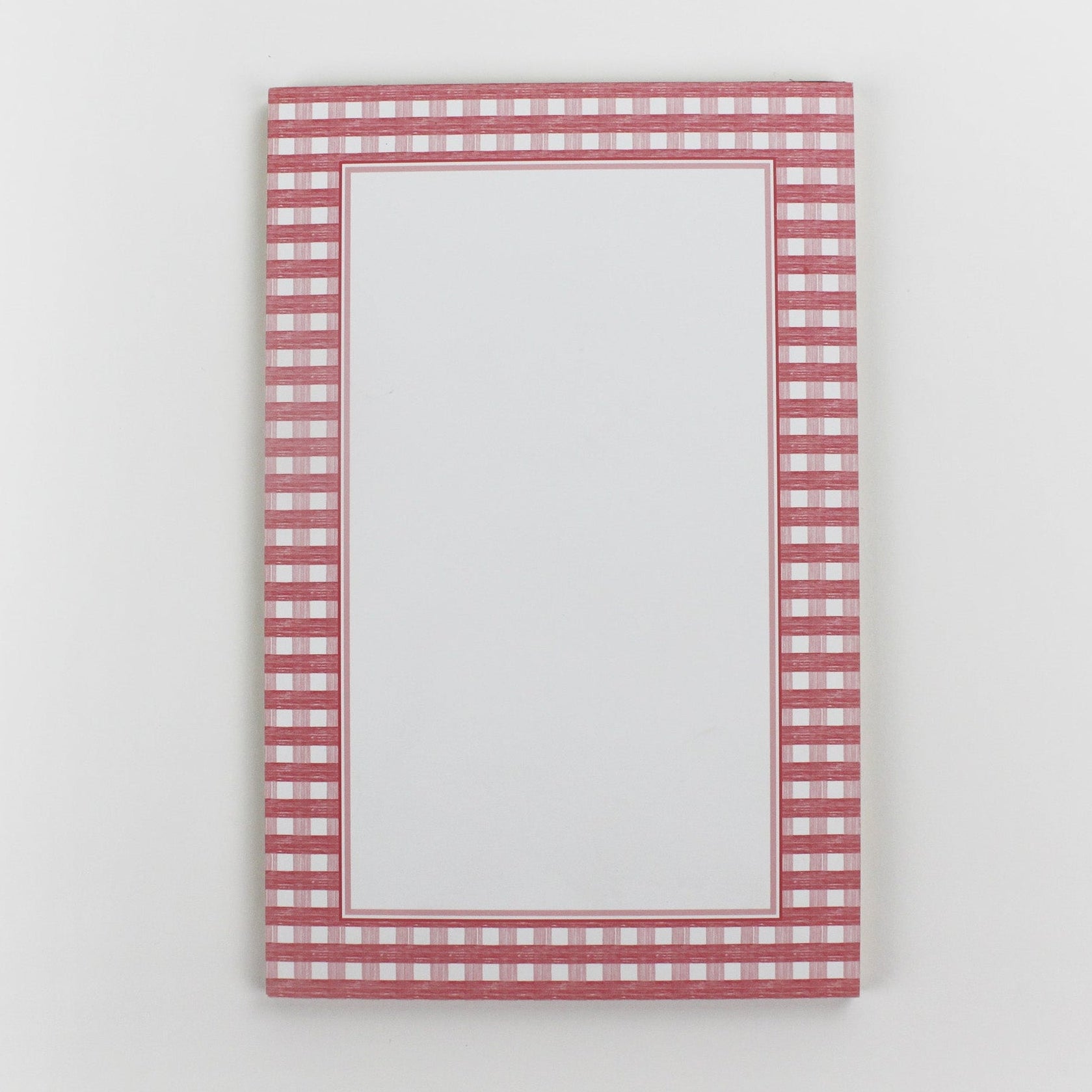 a pink luxury notepad from madcap cottage with a pink gingham border