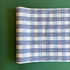 A blue roll of gingham wrapping paper 