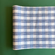A blue roll of gingham wrapping paper 