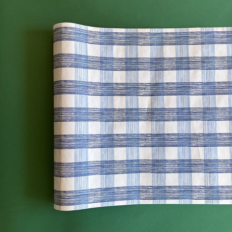 A blue roll of gingham wrapping paper 