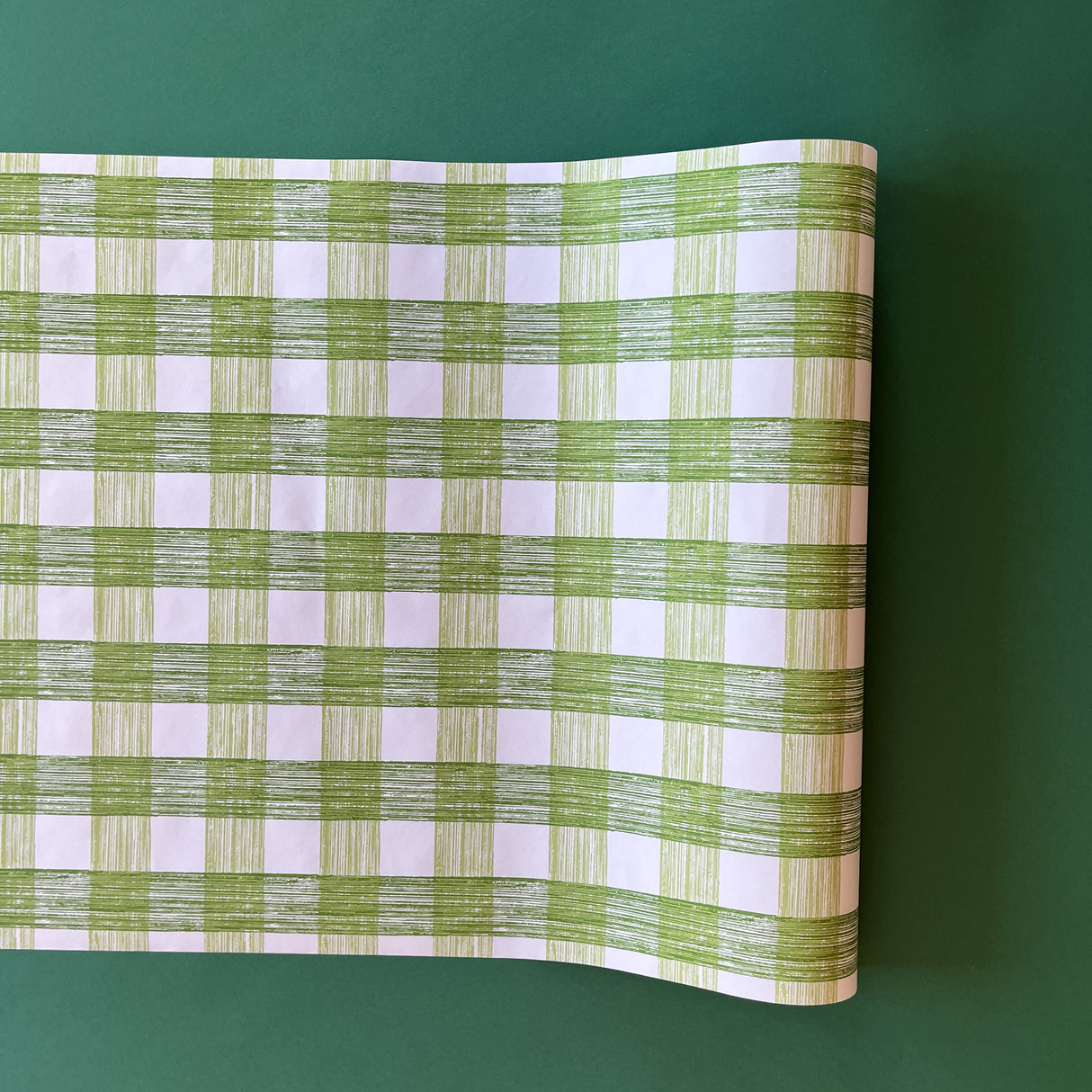 A green roll of gingham wrapping paper 