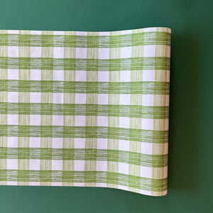 A green roll of gingham wrapping paper 