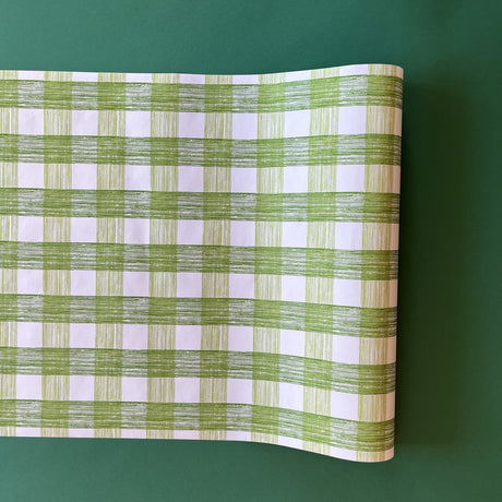 A green roll of gingham wrapping paper 