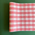 A pink roll of gingham wrapping paper 