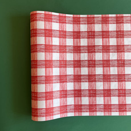 A red roll of gingham wrapping paper 